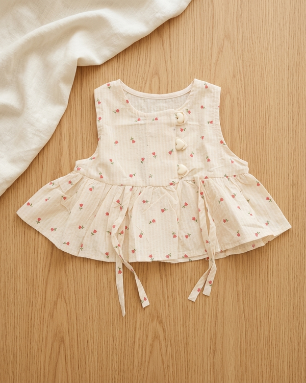 Blush Blooms: Toddler Girls' Cream Peplum Top with Heart Buttons & Side Ties